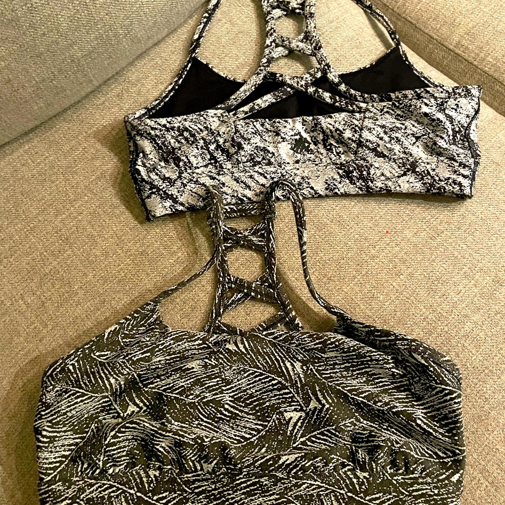 All in motion sports bras. braided back. Two bras (green/white) (black/white)
